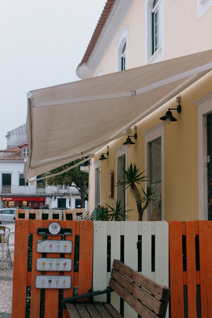Cozy outdoor café with colorful awnings and benches in Caldas da Rainha, Portugal.