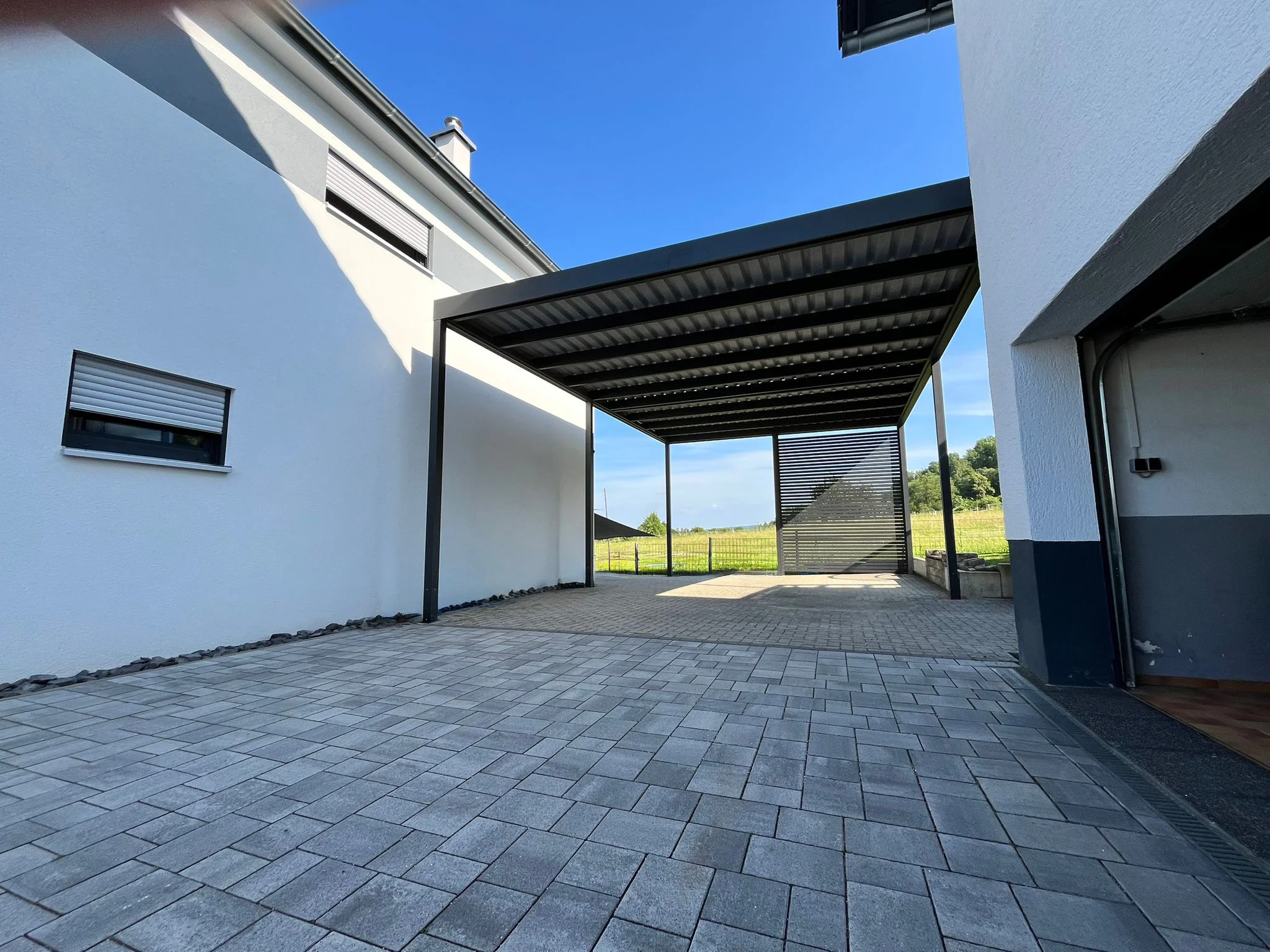 Carport als Hausdurchfahrt aus Aluminium mit Trapezdach in Köln
